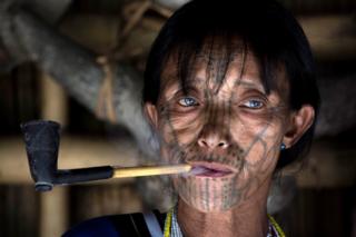 in_pictures A tattooed woman smokes a pipe