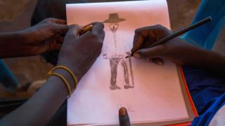 Children drawing in Juba