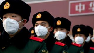 Chinese police officers wearing face masks