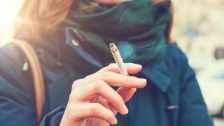 Woman in anorak smoking