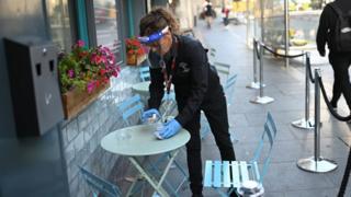 A waitress clearing a table in Liverpool