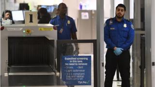 Transportation Security Administration officers (TSA) stand on duty at the departure area of the Los Angeles International Airport in Los Angeles, California, on 5 January, 2019. - TSA staff are taking sick leave in record numbers since the partial government shutdown forced them to work without pay began on Deember 22, 2018.