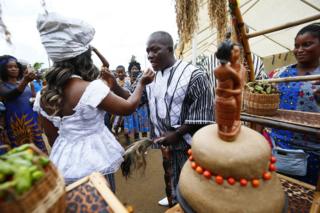 The groom, Sando G. Brownell (R) and the bride, Vester Sayee (L) share wedding cake, during their traditional wedding ceremony held in the Mount Barclay Community, a suburb of Monrovia, Liberia, 30 June 2018
