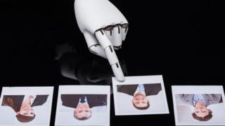 Close-up Of A Robot's Hand Selecting Candidate Photograph