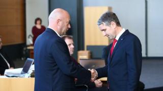 New Thuringia Prime Minister Thomas L. Kemmerich (L) of FDP shakes hands with Bjoern Hoecke of AfD