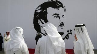 قطريون أمام جدارية للأمير تميم بن حمد آل ثاني