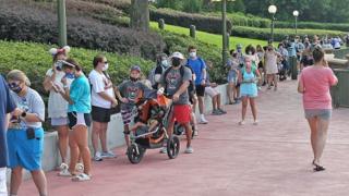 People queue outside Disney's Magic Kingdom