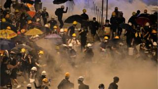 Protesters run away from tear gas