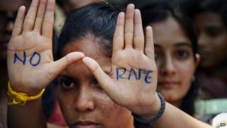 An Indian student displays "NO RAPE" message painted on her hands during a demonstration to demand death sentence for four men convicted of rape and murder of a student on a moving bus in New Delhi