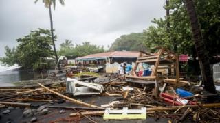 People clear debris in Le Carbet, on the French Caribbean island of Martinique, after it was hit by Hurricane Maria.