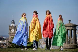 Dressed in giant capes, children take part in "The Tallest" one of over 100 pop-up performances featured in this year's Edinburgh International Children's Festival