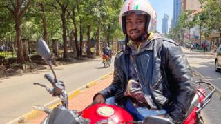 Moses Lugalia on his electric motorbike in Nairobi, Kenya