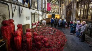 People look at an installation titled Coming Home by artist Martin Waters at Hull Minster.