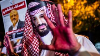 Demonstran mengenakan topeng Pangeran Mohammad bin Salman