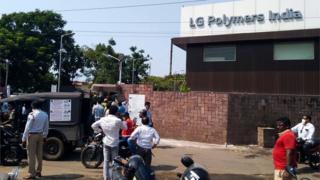 A crowd gathers outside the LG Polymer factory after the gas leak