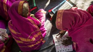 two women checking a textbook