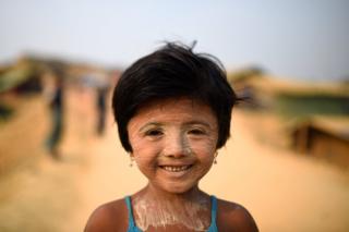   Refugee Rohingya Nur Kayas, 6 years old, poses for a picture as she carries dough at Kutupalong camp in Cox bazaar, Bangladesh 