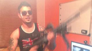Ashkan Ebrahimi holding a gun