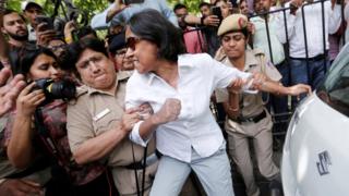 A protester is arrested by police outside of India's supreme court