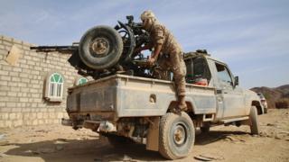 Armed Yemeni tribesman loyal to President Abdrabbuh Mansour Hadi aims a machine-gun in the Sirwah area on 7 December 2015