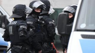 Policemen of a special unit stand next to their cars on the grounds of the Bilal mosque in the Griesheim district of Frankfurt am Main (1 Feb)