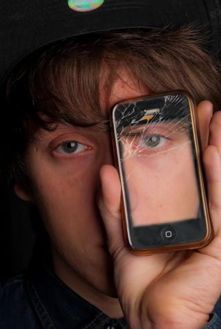 Person holding mobile phone in front of their face