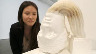 A Sculpture of a head made from paper