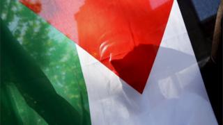 A Palestinian refugee holds the flag during a protest in Madrid, Spain, on 21 July 2015.