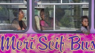 Women laughing on bus