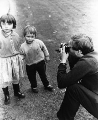 Robert Blomfield photographing two children, taken by his wife Jane.