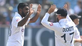 England players Rehan Ahmed (left) and Ben Duckett (right) high five to celebrate a wicket