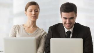 Mulher espiando conversa de homem em computador