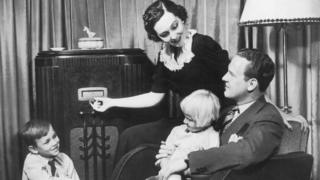 parents and children listening to radio set