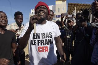 Supporters celebrate in a street of Dakar after the courthouse has decided to release activist Kemi Seba from the Rebeuss jailhouse on August 29, 2017. Kemi Seba was arrested after he burned a 5,000 CFA franc bank note during a meeting on August 19, 2017.