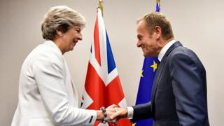 Theresa May shakes hands with European Council President Donald Tusk