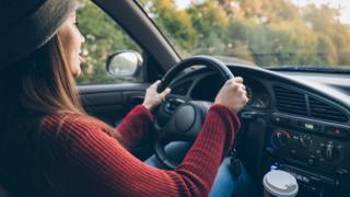 Woman driver and coffee