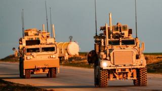US Marine Corps tactical vehicles are seen driving along a road near the town of Tal Baydar in the countryside of Syria's northeastern Hasakeh province on December 21, 2018