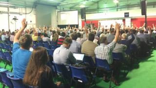 Audience members vote in a straw poll at the end of the debate