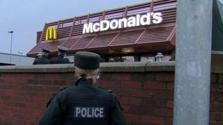 Police officers at McDonalds on Glenmachan Street in Belfast