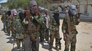 Al-Qaeda linked al-shabab recruits walk down a street on March 5, 2012 in the Deniile district of Somali capital, Mogadishu
