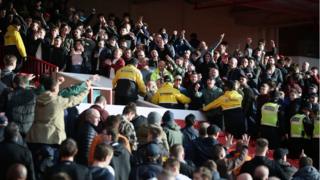 Forest and Derby fans gesture towards each other