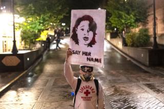 Protester holds picture of Breonna Taylor