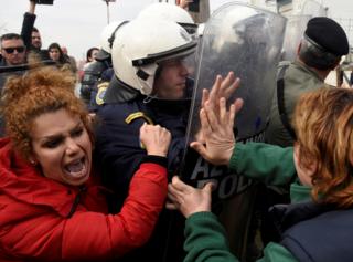 Migrants and refugees, who say that they seek to travel onward to northern Europe, scuffle with police officers near the town of Diavata in northern Greece. 5 April 2019.