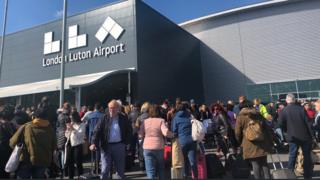 Passengers outside Luton airport