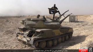 IS fighter on a captured tank in al-Qaryatain (picture by Rased News Network, a Facebook page affiliated with IS via AP - 06/08/15)
