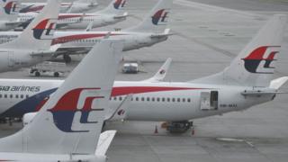 Malaysia Airlines planes are seen at departure gates at Kuala Lumpur International Airport (KLIA) in Sepang on March 8, 2015.