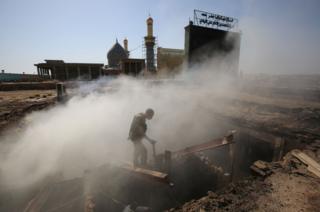 An Iraqi policeman inspects the aftermath