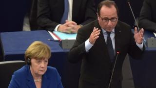 French President Francois Hollande (right) delivers a speech next to German Chancellor Angela Merkel (left) during their joint address at the European Parliament (07 October 2015)