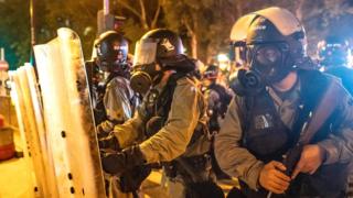 Riot police stand-off with protesters in the Kwai Fong district