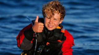 French skipper Tom Goron, 12, reacts after breaking the record for the crossing of the English Channel onboard an optimist boat